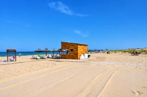 a sandy beach with a building on the beach at Beachfront Luxury Apartments by NRAS in Arenales del Sol
