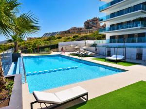 a swimming pool on the side of a building at Beachfront Luxury Apartments by NRAS in Arenales del Sol