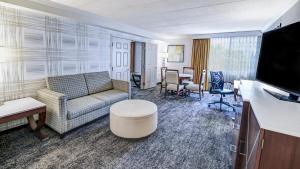 a living room with a couch and a table at DoubleTree by Hilton Madison Downtown in Madison