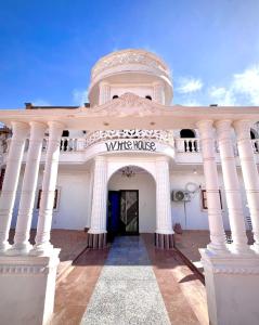 a white building with a white horse sign on it at The white House in Aswan