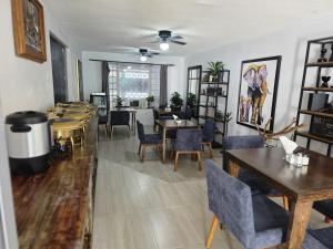 a room with tables and chairs and a dining room at 25 Habitación doble cama in Miravalle +2 photos