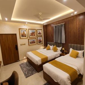 a hotel room with two beds in it at Hotel Banaras Vandanam in Varanasi