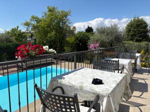 a patio with a table and chairs next to a pool at Hotel Renata in Lazise