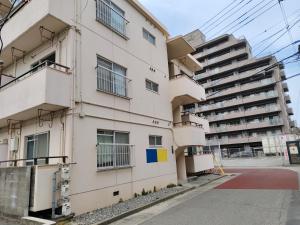 an apartment building with balconies on the side of it at 徳島駅徒歩10分 公園前 Netflix DiDi Base 203 in Tokushima