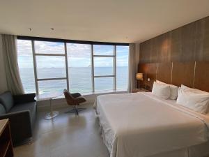 a bedroom with a large bed and large windows at Hotel Nacional Rio in Rio de Janeiro +8 photos