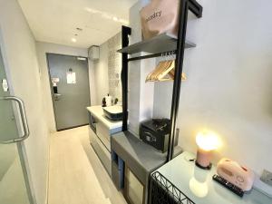 a bathroom with a sink and a counter with a lamp at Heritage Collection on Arab - Mobile App Check-In in Singapore