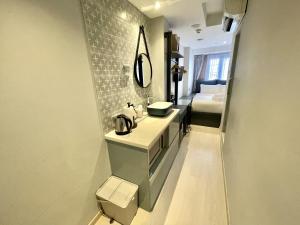 a bathroom with a sink and a bed in a room at Heritage Collection on Arab - Mobile App Check-In in Singapore