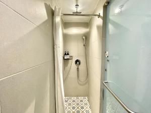 a walk in shower in a bathroom with a glass door at Heritage Collection on Arab - Mobile App Check-In in Singapore +18 photos