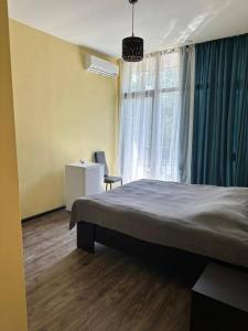 a bedroom with a large bed and a window at TheStarryNight in P'ichvnari +7 photos