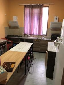 a kitchen with a table and a sink and a window at TheStarryNight in P'ichvnari