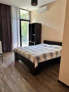 a bedroom with a bed in a room with a window at TheStarryNight in P'ichvnari