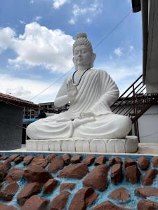 a large statue sitting on top of a building at Bhudda Lodge in Tirupati