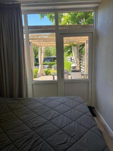 a bedroom with a bed in front of a window at De Drentse Rust - Het Atelier in Emmer-Compascuum