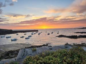 a group of boats in the water at sunset at Chez Simone in Ploemeur
