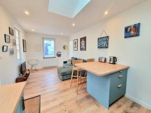 a kitchen and living room with a wooden counter top at Chez Simone in Ploemeur