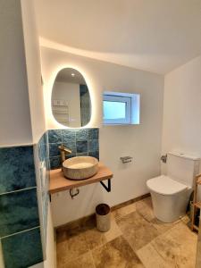 a bathroom with a sink and a toilet at Chez Simone in Ploemeur +12 photos