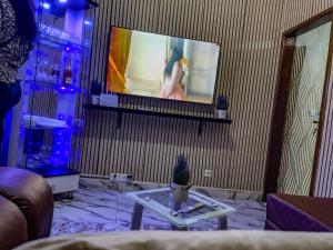 a living room with a flat screen tv on a wall at Wiwi Appartement in Kinshasa