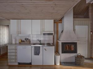 a kitchen with white appliances and a stove at Polar Tranquil Cabins in Kittilä