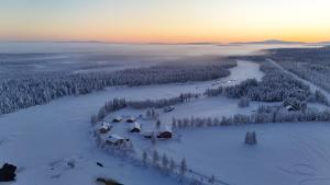 an aerial view of a house in the snow at Polar Tranquil Cabins in Kittilä +6 photos