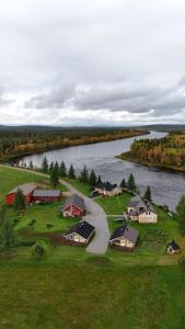 an aerial view of a village next to a river at Polar Tranquil Cabins in Kittilä