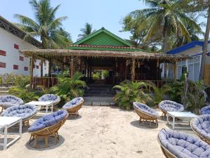 a group of chairs and tables in front of a building at Stay in Paradise Koh Rong in Koh Rong Island +44 photos