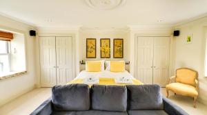 a bedroom with a large bed and a couch at Estatesmen Lodge, Hillside Farm in Kirkby Stephen
