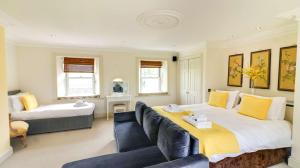 a bedroom with a large bed and a couch at Estatesmen Lodge, Hillside Farm in Kirkby Stephen