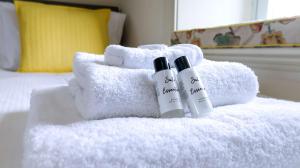 two bottles of sunscreen sitting on top of a white towel at Estatesmen Lodge, Hillside Farm in Kirkby Stephen +112 photos