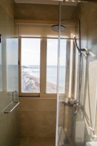a bathroom with a shower with a view of the beach at Mia Beach Hotel in Cù Lao Thu +76 photos