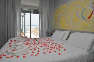 a bedroom with a bed with red roses on it at Hotel Luna in Sirmione