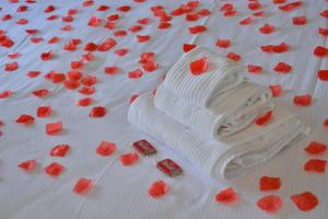 a white cake with red flowers on top of it at Hotel Luna in Sirmione