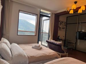 a hotel room with a bed and a window at 泰森會館 in Lugu Lake +46 photos