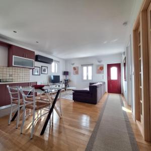 a kitchen and living room with a table and chairs at Philoxenia Home in Áyios Pétros