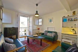 a living room with a couch and a tv at Apartments in downtown in Lisbon