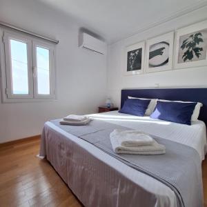 a bedroom with a large bed with two towels on it at Philoxenia Home in Áyios Pétros