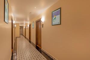 a hallway of a hospital with a tile floor at Treebo Green Pearl Inn in Guwahati