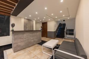 a lobby with a couch and a table and some stairs at Echor Alpine Meadows Khajjiar Dalhousie in Khajjiar  +60 photos