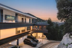 two cars parked in front of a building at Echor Alpine Meadows Khajjiar Dalhousie in Khajjiar 