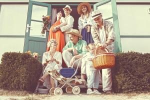 an old picture of a family posing in front of a house at Jardin Jannik in Watou +32 photos