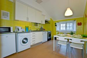 a kitchen with a washer and dryer in it at Apartments in downtown in Lisbon