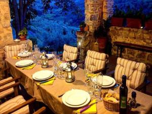 a table with plates and glasses and a bottle of wine at Agriturismo Villa Dauphiné in Bagno a Ripoli
