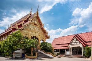 a building with a tree in front of it at Boutique House Nipha in Chiang Mai