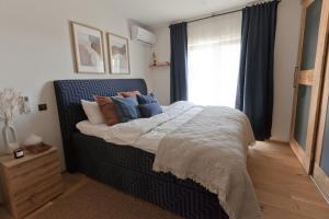 a bedroom with a bed with pillows and a window at Rooftop Spa Villa Kuressaare in Kuressaare