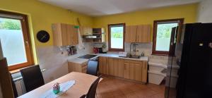 a kitchen with yellow walls and a table with a table sidx sidx sidx at Apartment Pepca in Čezsoča