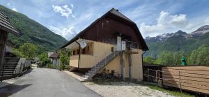 a small building with a staircase on the side of it at Apartment Pepca in Čezsoča