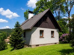 a small house with a gambrel roof on a hill at Chata Růžová in Růžová