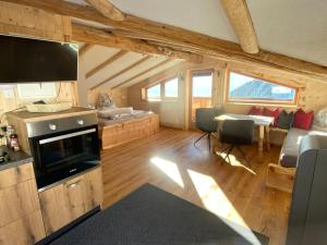 a kitchen and living room in a log cabin at Chalet in Zillertal near Hochzillertal Ski Area in Zellberg
