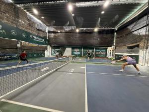 a group of people playing tennis on a tennis court at Tuna Homestay Hanoi & Experience in Hanoi