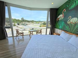 a bedroom with a bed and a large window at Starview Villa Dalat in Da Lat +46 photos