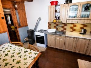 a kitchen with a table and a stove top oven at Chata Růžová in Růžová